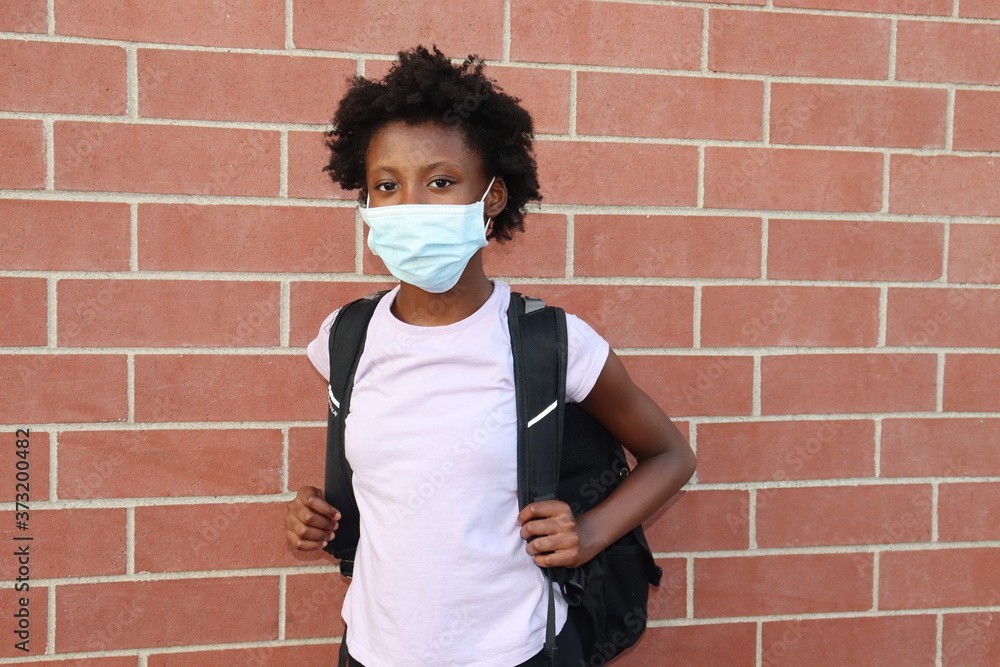 Black girl wearing mask outside school